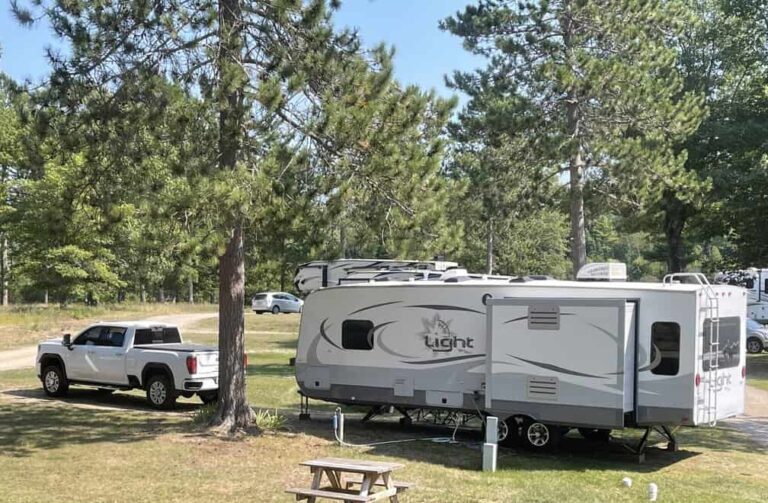 a truck and RV trailer in a campground