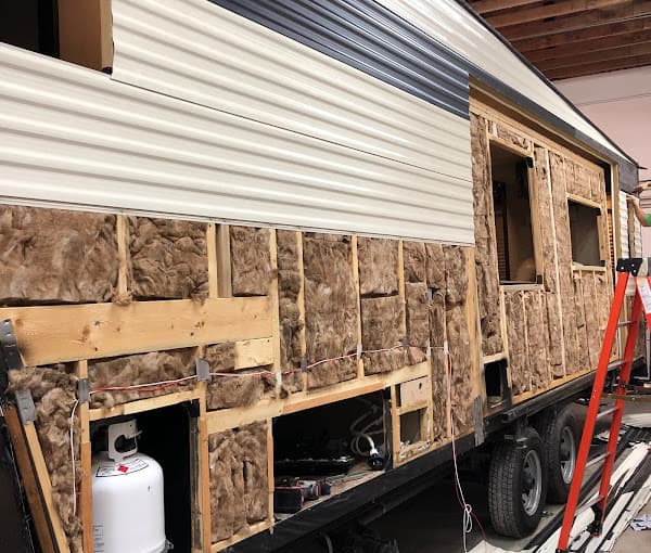 The side of a large travel trailer undergoing severe rv renovation.