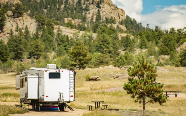 A travel trailer with slides is RVing in state parks that are remote, with no visible connectivity.