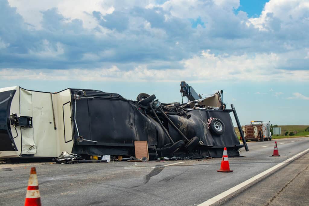 Large travel trailer Recreational Vehicle overturned on a highway