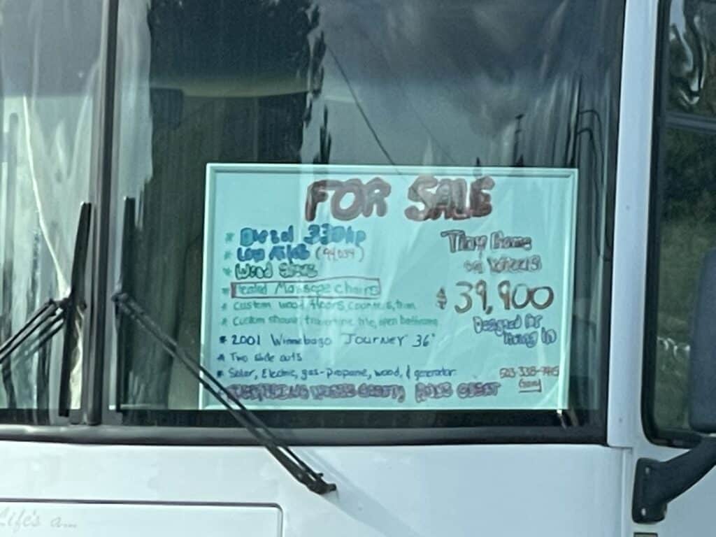 a for sale sign in the window of a motorhome