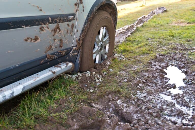 The wheels of motorhome stuck in the mud.
