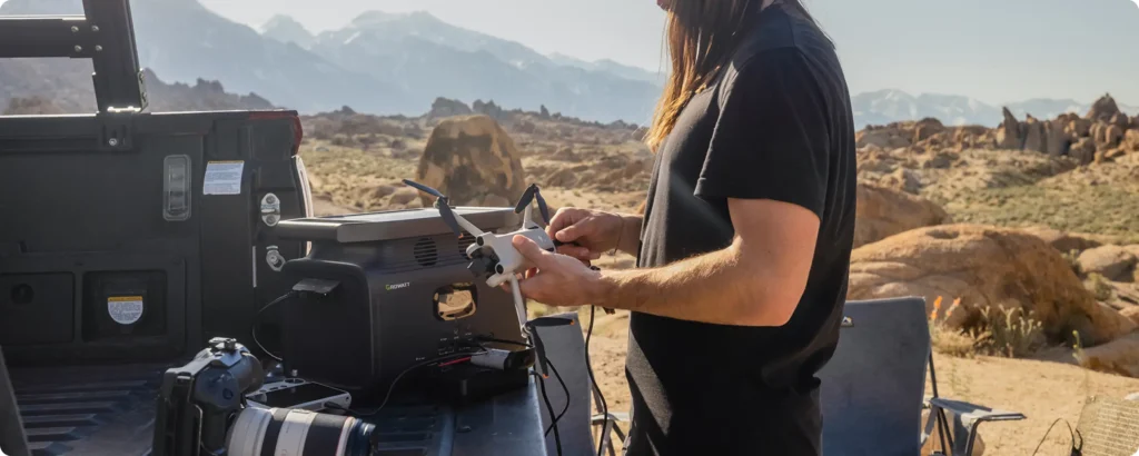 A man charges a drone with the Growatt INFINITY 1300