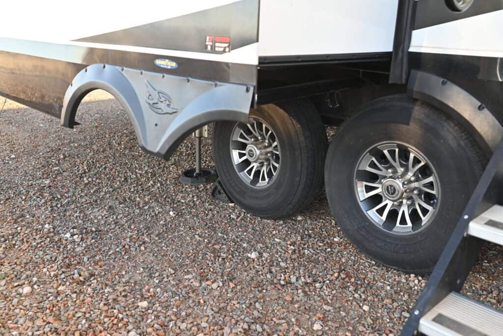 5th Wheel tires, steps, and jacks shown with slide extended.
