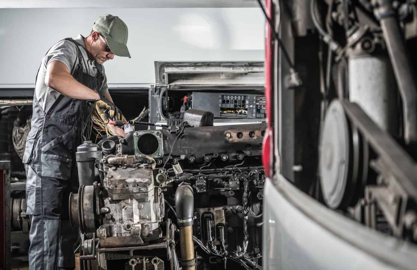 mechanic works on engine in diesel rv maintenance