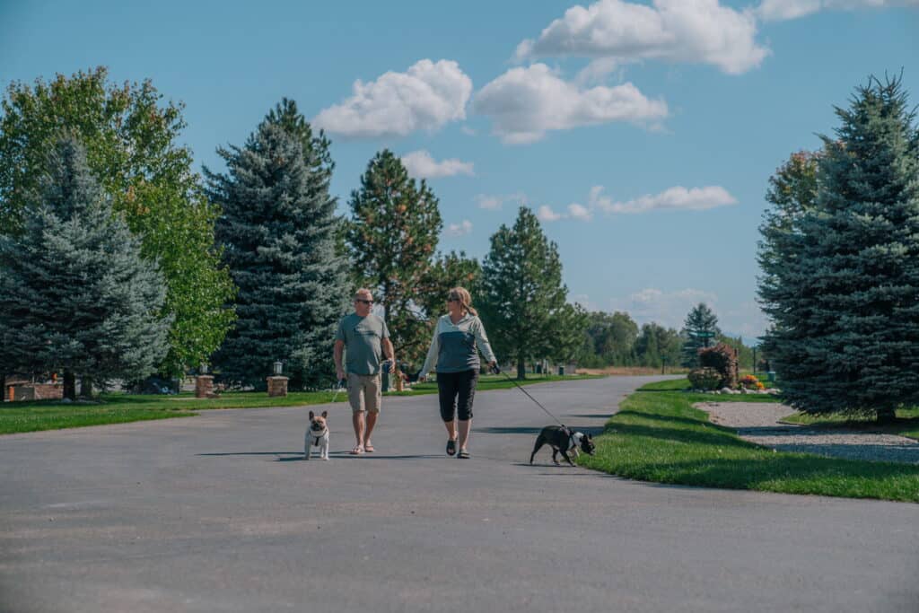 A couple walk their dogs at StoneRidge Resort