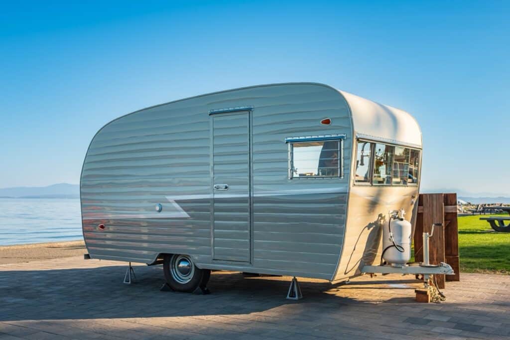 Pre-owned vintage RV on a beachfront site.
