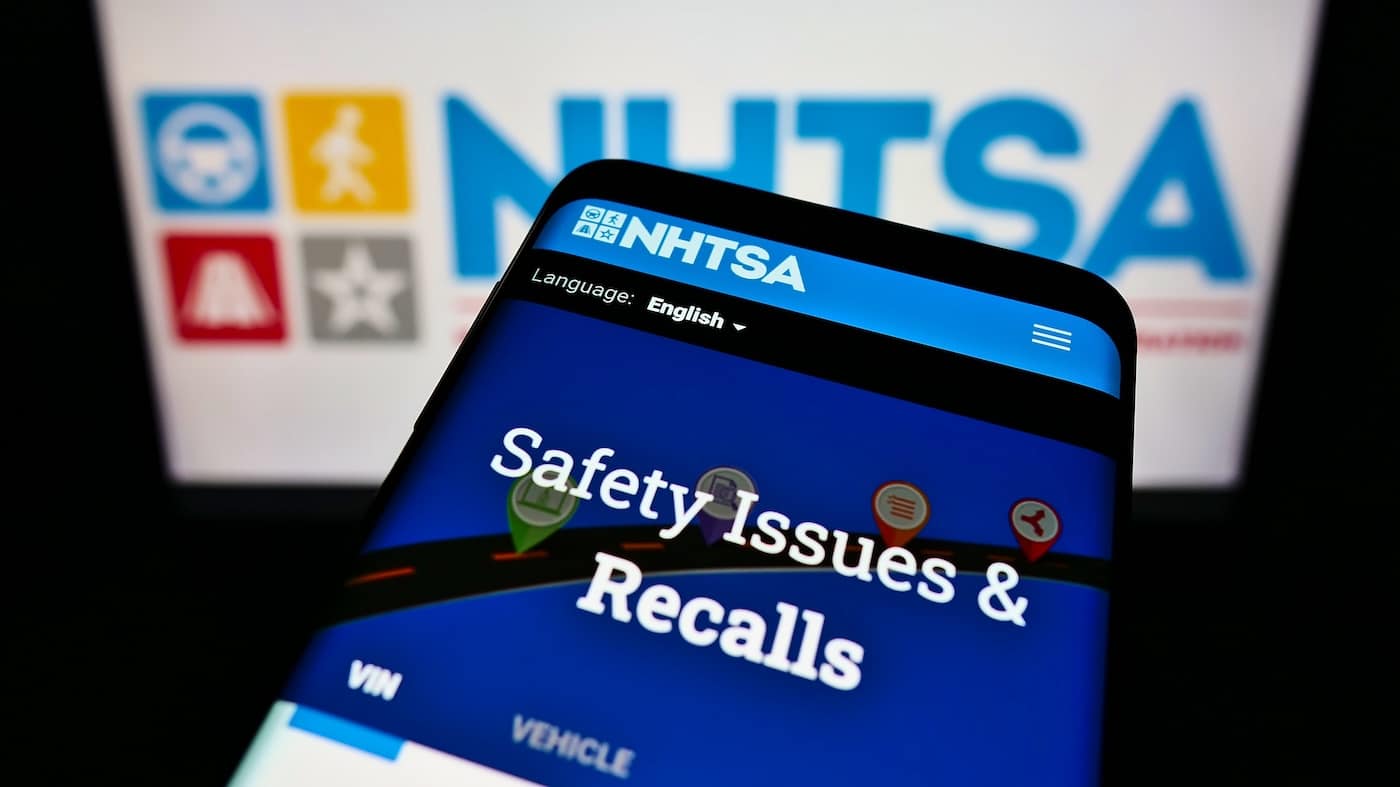 NHTSA RV Recalls: Image with mobile phone screen and computer screen in background