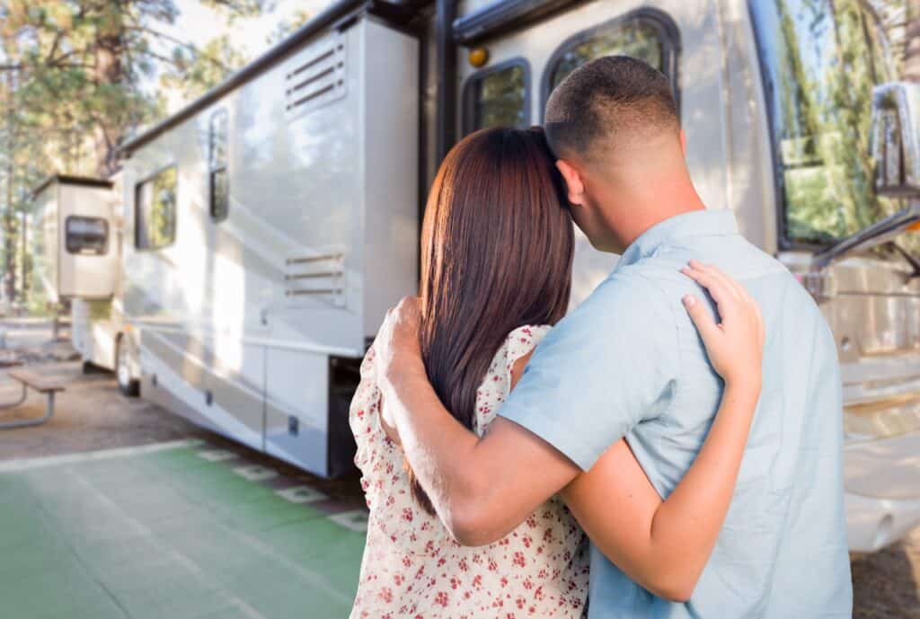 Young couple admiring their new rig after buying an RV online.