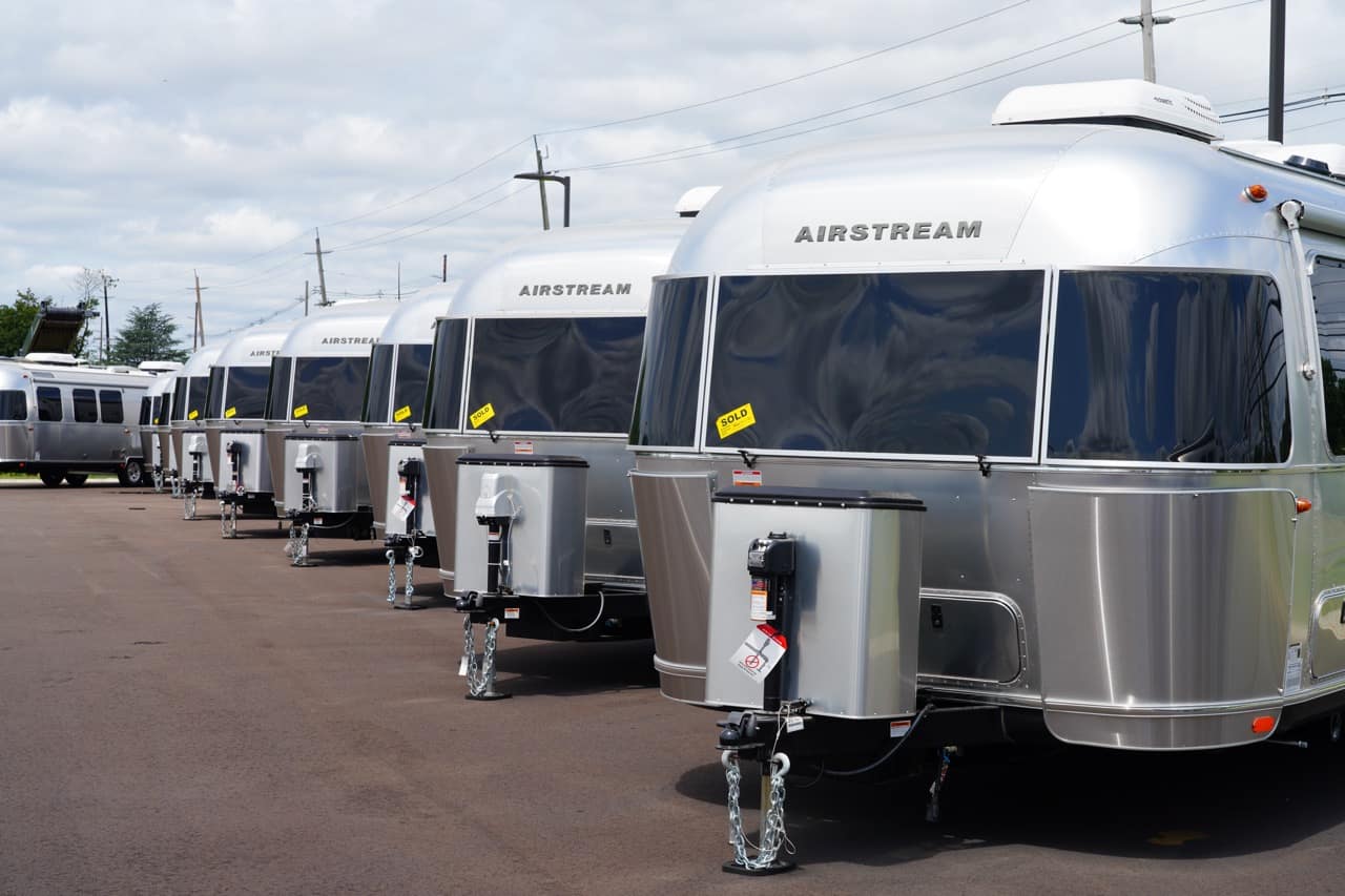 A line of Airstream trailers at an RV show.