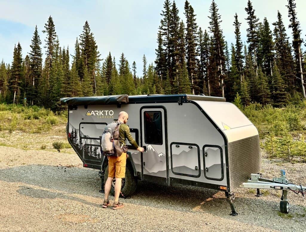 Arkto Campers G12 in travel mode with an RVer opening the door. Photo: Arkto Campers.