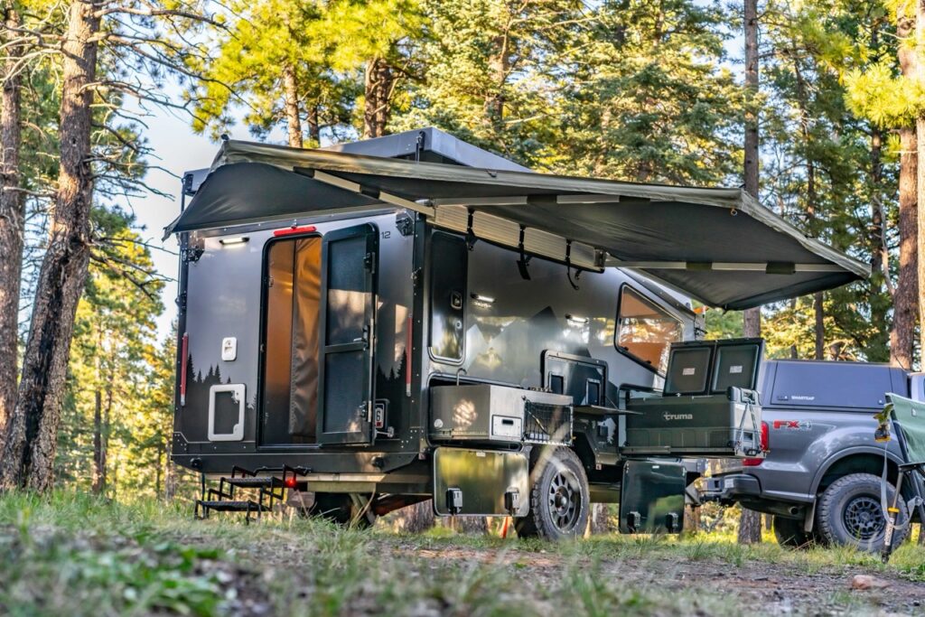 Boreas Campers EOS-12 trailer RV with solar power set up in camp.